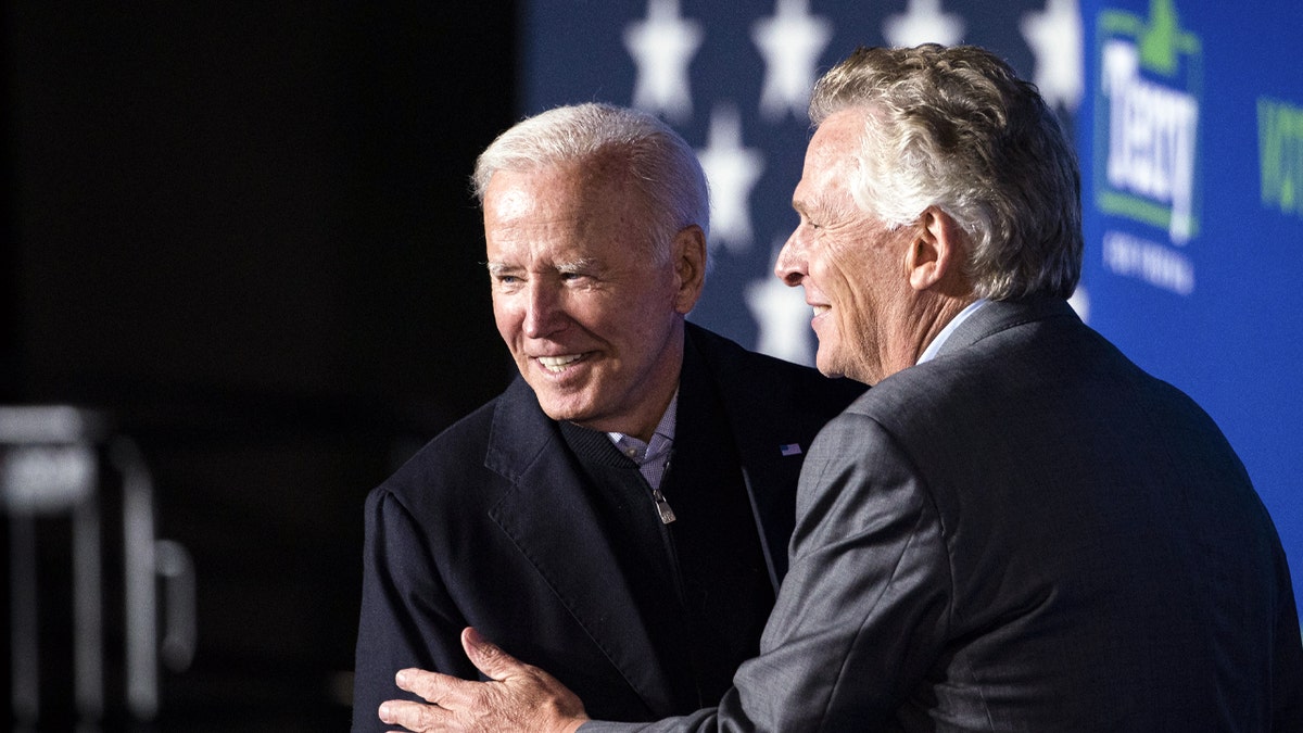 U.S. President Joe Biden greets Terry McAuliffe, Democratic gubernatorial candidate for Virginia, during a campaign event in Arlington, Virginia, U.S., on Tuesday, Oct. 26, 2021.