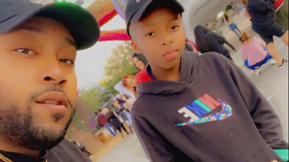 This photo provided by Taylor Blount shows Ezra Blount, right, and his father, Treston Blount, left, posing outside the Astroworld music festival in Houston. Both were injured later at the concert during a crowd surge. 