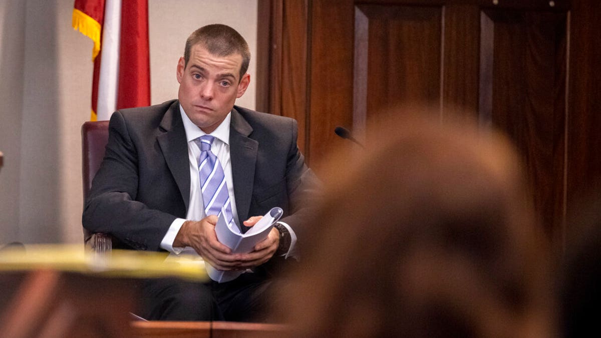 Glynn County Police Officer Jeff Brandeberry sits on the witness stand during the trial of Greg McMichael and his son, Travis McMichael, and a neighbor, William "Roddie" Bryan in the Glynn County Courthouse, Tuesday, Nov. 9, 2021, in Brunswick, Ga. (AP Photo/Stephen B. Morton, Pool)