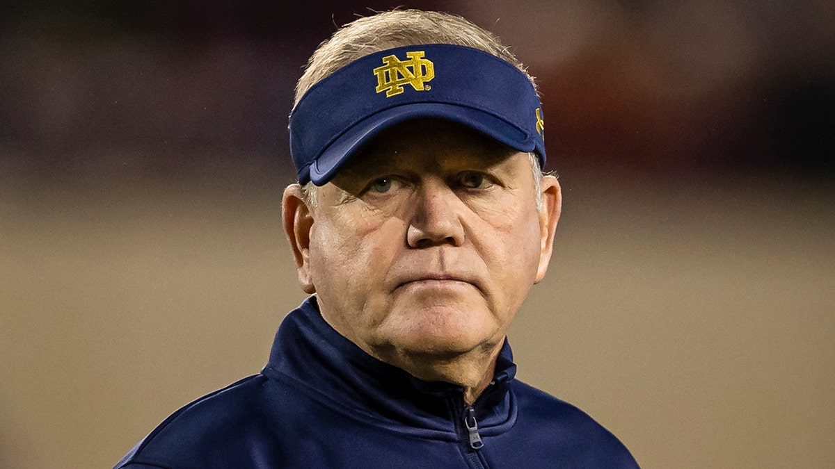 Head coach Brian Kelly of the Notre Dame Fighting Irish watches over the team before the game against the Virginia Tech Hokies at Lane Stadium on October 9, 2021 in Blacksburg, Virginia.