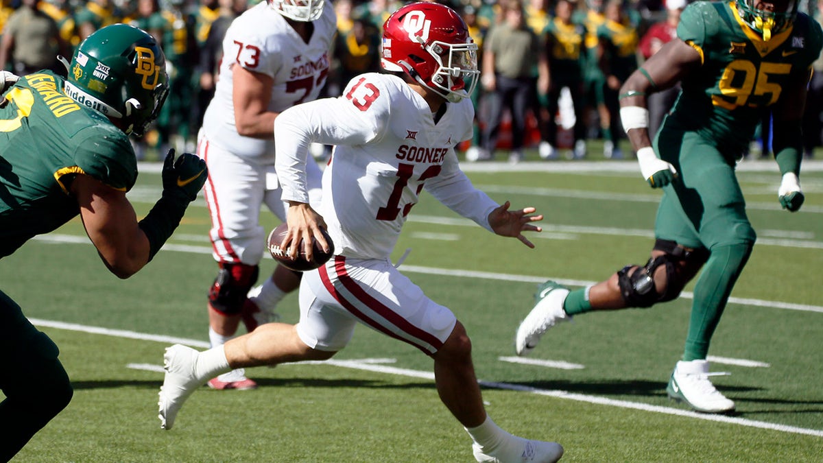 Oklahoma quarterback Caleb Williams (13) scrambles for positive yards against Baylor during the first half in Waco, Texas, Saturday, Nov. 13, 2021.