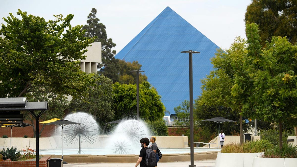 People walk on the California State University Long Beach (CSULB) campus before the return of students for Fall classes on August 11, 2021 in Long Beach, California. - All teachers in California will have to be vaccinated against Covid-19 or submit to weekly virus tests, the state's governor announced June 11, as authorities grapple with exploding infection rates. (Photo by Patrick T. FALLON / AFP) (Photo by PATRICK T. FALLON/AFP via Getty Images)