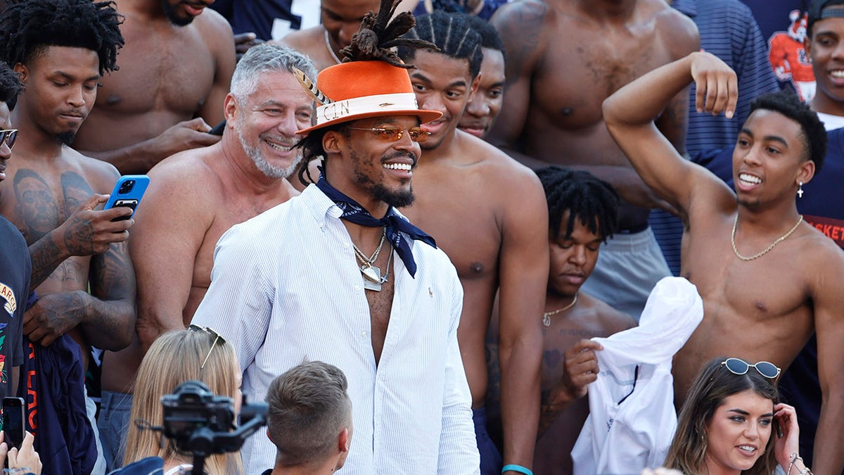 Former Auburn Tigers and NFL quarterback Cam Newton joins Auburn Tigers head basketball coach Bruce Pearl and his team in the stands at Jordan-Hare Stadium before an Auburn football game against the Georgia Bulldogs Oct 9, 2021. 