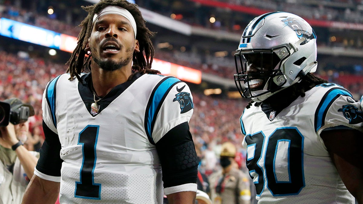 Carolina Panthers quarterback Cam Newton celebrates his touchdown against the Arizona Cardinals with Panthers tight end Ian Thomas on Sunday, Nov. 14, 2021, in Glendale, Arizona.