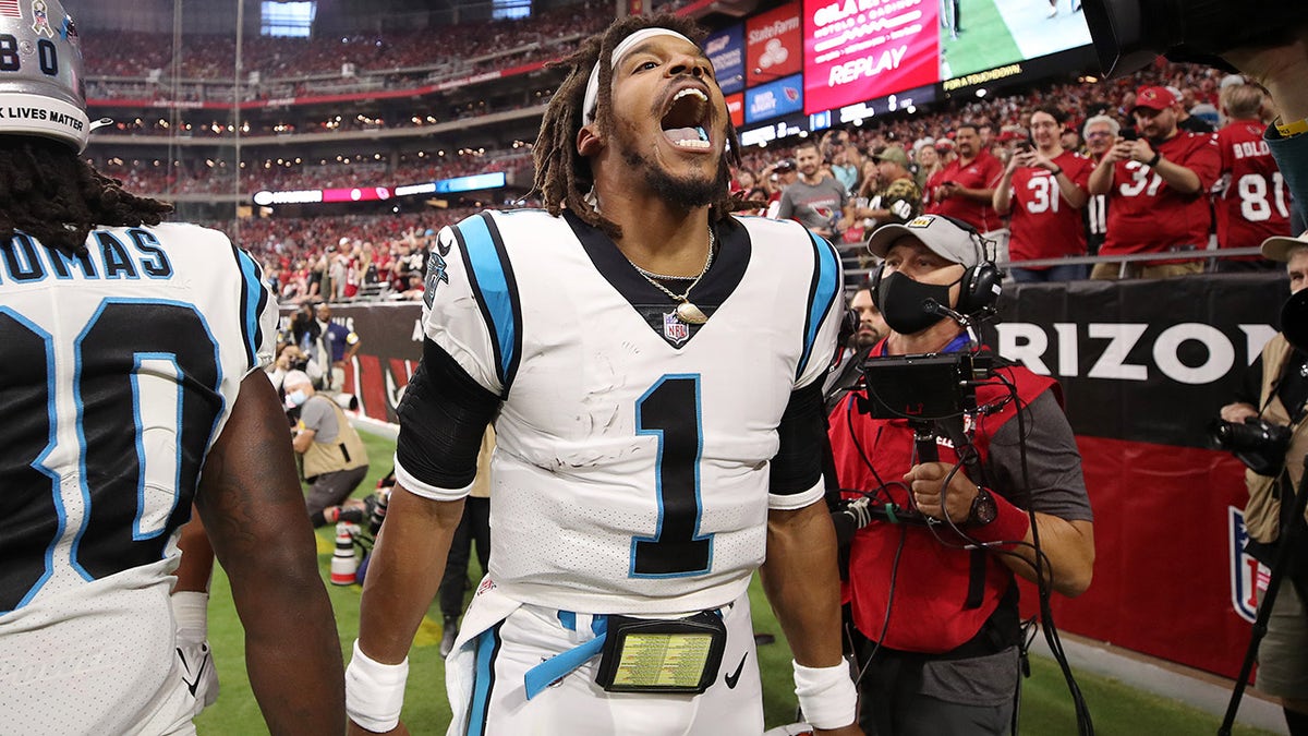 GLENDALE, ARIZONA - NOVEMBER 14: Cam Newton #1 of the Carolina Panthers reacts after scoring on a rushing touchdown against the Arizona Cardinals in the first quarter at State Farm Stadium on November 14, 2021 in Glendale, Arizona.
