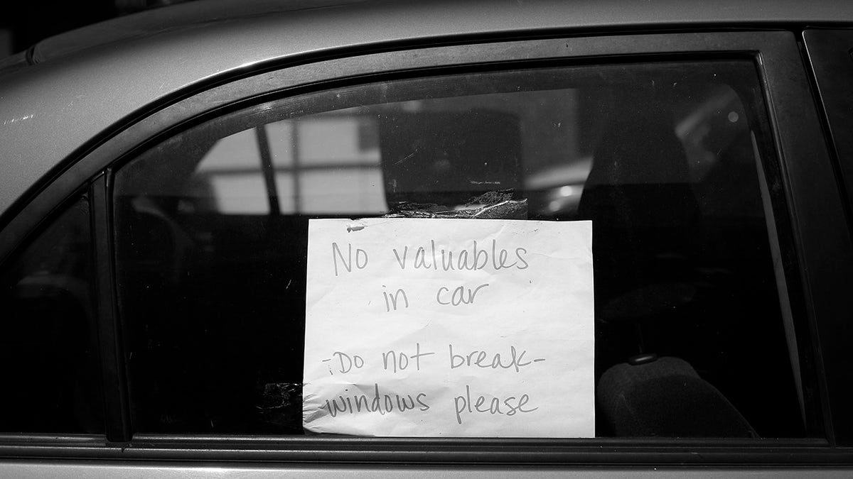 A sign in a car window in San Francsico asks not to be broken into