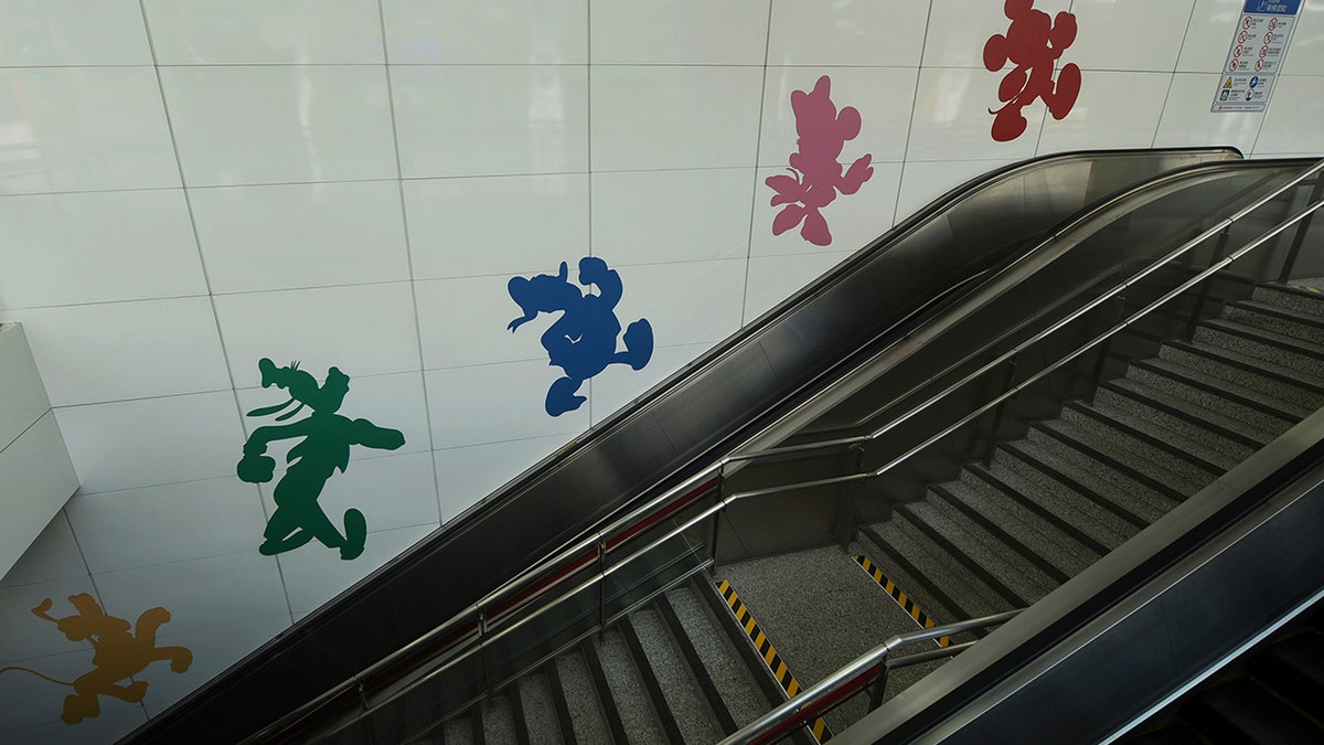 Disney characters on a wall next to the escalator inside a closed subway station at the Shanghai Disney Resort in Shanghai, China, on Monday.