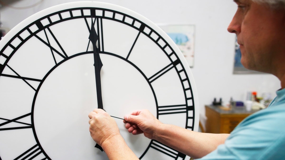 Scott Gow assembles a clock dial for a four-dial street clock headed to the Lincoln Haymarket Historic District in Nebraska at the Electric Time Company in Medfield, Massachusetts November 1, 2013. ?