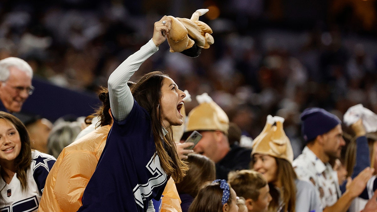 Fans cheer during the fourth quarter of the NFL game between the Las Vegas Raiders and Dallas Cowboys at AT&T Stadium on Nov. 25, 2021, in Arlington, Texas. 