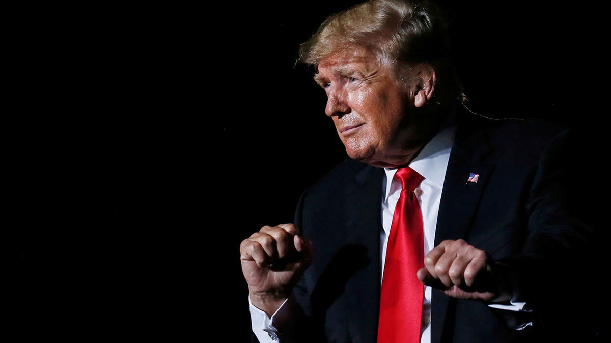 Former President Trump reacts after his speech during a rally at the Iowa State Fairgrounds in Des Moines, Iowa, Oct. 9, 2021