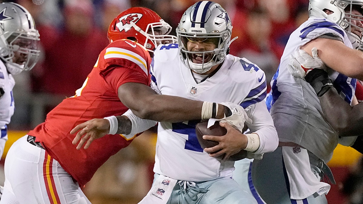 Dallas Cowboys quarterback Dak Prescott (4) is sacked by Kansas City Chiefs defensive tackle Chris Jones during the second half of an NFL football game Sunday, Nov. 21, 2021, in Kansas City, Missouri.