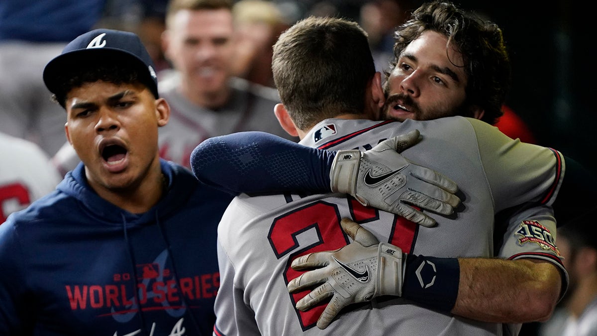 Atlanta Braves' Dansby Swanson celebrates a two-run home run with Austin Riley during the fifth inning in Game 6 of baseball's World Series between the Houston Astros and the Atlanta Braves Tuesday, Nov. 2, 2021, in Houston.