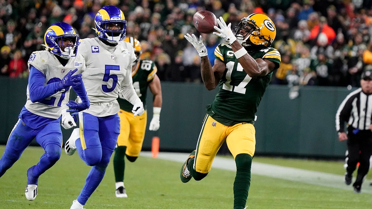 Green Bay Packers' Davante Adams catches a long pass in front of Los Angeles Rams' Jalen Ramsey during the first half of an NFL football game Sunday, Nov. 28, 2021, in Green Bay, Wisconsin.