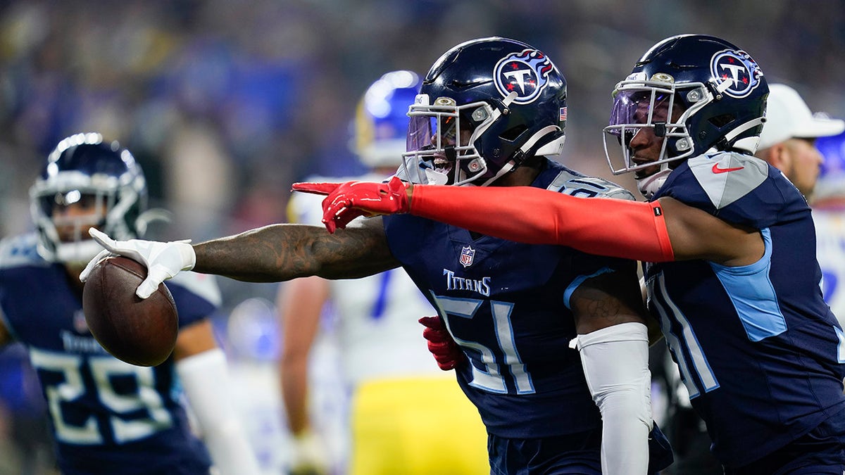 Tennessee Titans linebacker David Long, center, reacts with teammate free safety Kevin Byard after grabbing an interception during the first half of an NFL football game against the Los Angeles Rams, Sunday, Nov. 7, 2021, in Inglewood, California.