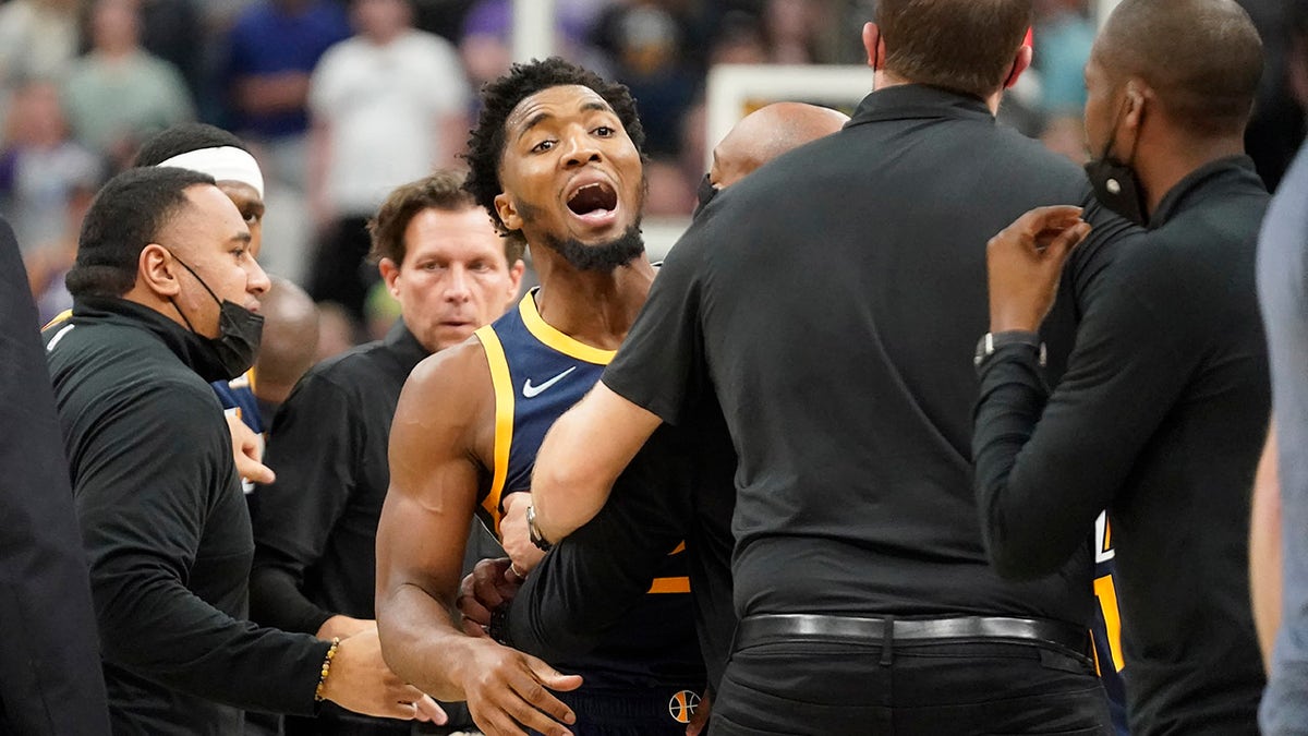 Utah Jazz guard Donovan Mitchell, center, tries to get to players from the Indiana Pacers after a fight between Jazz center Rudy Gobert and Pacers center Myles Turner in the second half during an NBA basketball game Thursday, Nov. 11, 2021, in Salt Lake City. Mitchell, Gobert and Turner were ejected from the game.