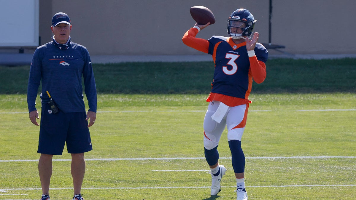 ENGLEWOOD, CO - AUGUST 18:  Quarterback Drew Lock #3 of the Denver Broncos throws a pass on the field as Offensive Coordinator Pat Shurmur looks on during a training session at UCHealth Training Center on August 18, 2020 in Englewood, Colorado.