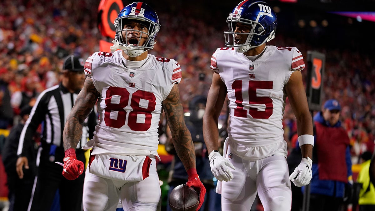 New York Giants' Evan Engram (88) is congratulated by Collin Johnson (15) after scoring during the second half of an NFL football game Monday, Nov. 1, 2021, in Kansas City, Mo.