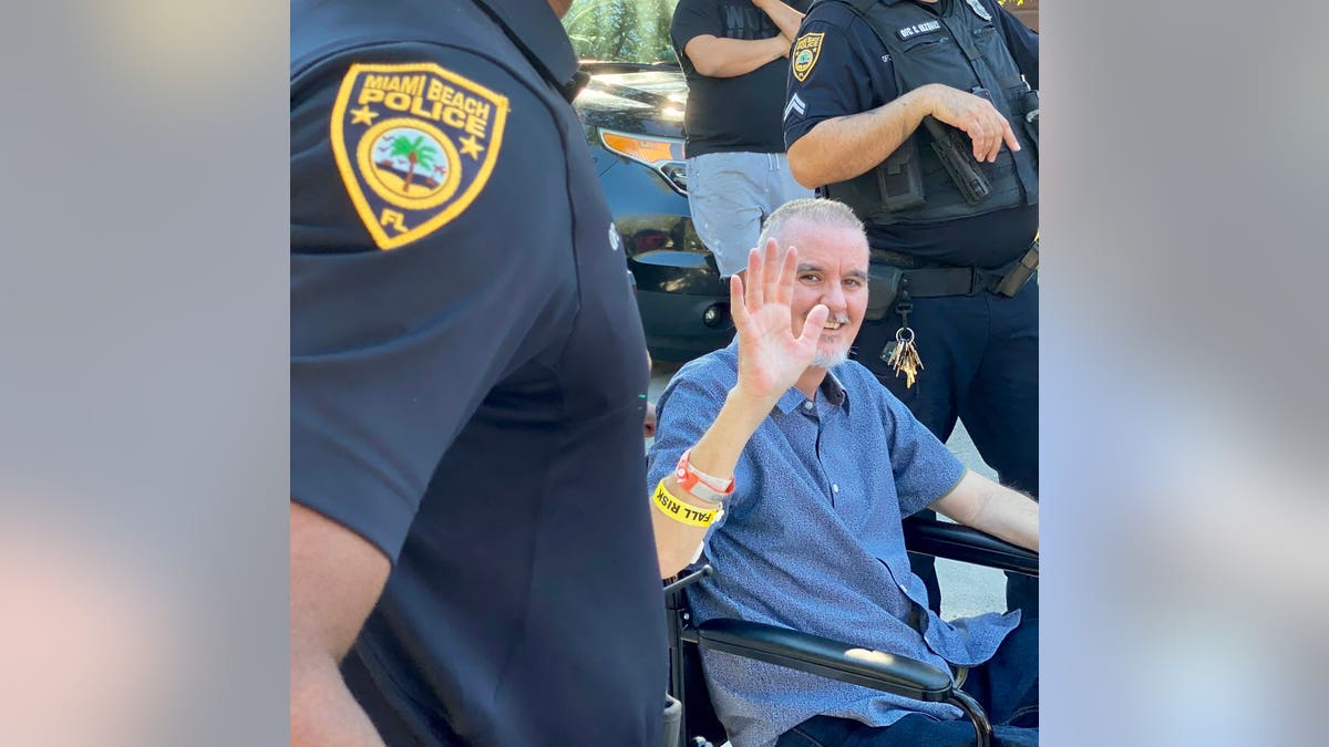 Miami Beach Police Officer JC Sampedro waves after being discharged from the Broward Health North facility on Monday, Nov. 15, 2021. Photo Credit: Twitter @MiamiBeachPD