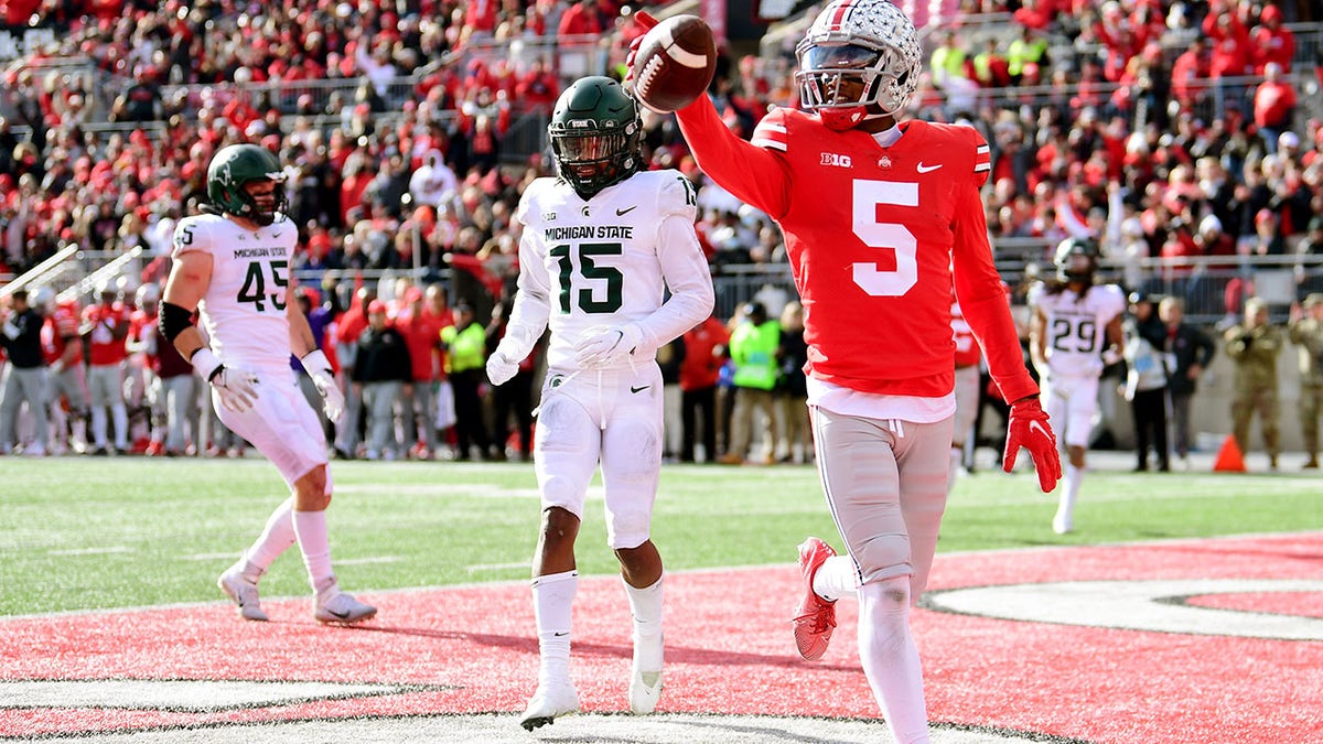 COLUMBUS, OHIO - NOVEMBER 20: Garrett Wilson #5 of the Ohio State Buckeyes celebrates his touchdown during the first half of a game against the Michigan State Spartans at Ohio Stadium on November 20, 2021 in Columbus, Ohio. 