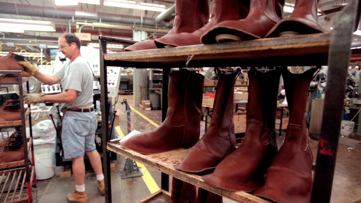 Red Wing, Mn., Tues., May 15, 2001--Tour of Red Wing Boot Co. manufacturing plant and of the S B Foot Tanning Co. ehich is owned by Red Wing and supplies its leather. IN THIS PHOTO: Ken Frazier forms the toes of boots with a heat press. That's some of his product on the rack. )DUANE BRALEY/Star Tribune via Getty Images)