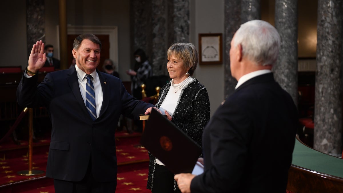 Senator Mike Rounds, R-S.D., participates in a mock swearing-in for the 117th Congress with Vice President Mike Pence, as his wife Jean Rounds holds a bible, in the Old Senate Chamber at the US Capitol in Washington, DC on January 3, 2021. (Photo by KEVIN DIETSCH/AFP via Getty Images)
