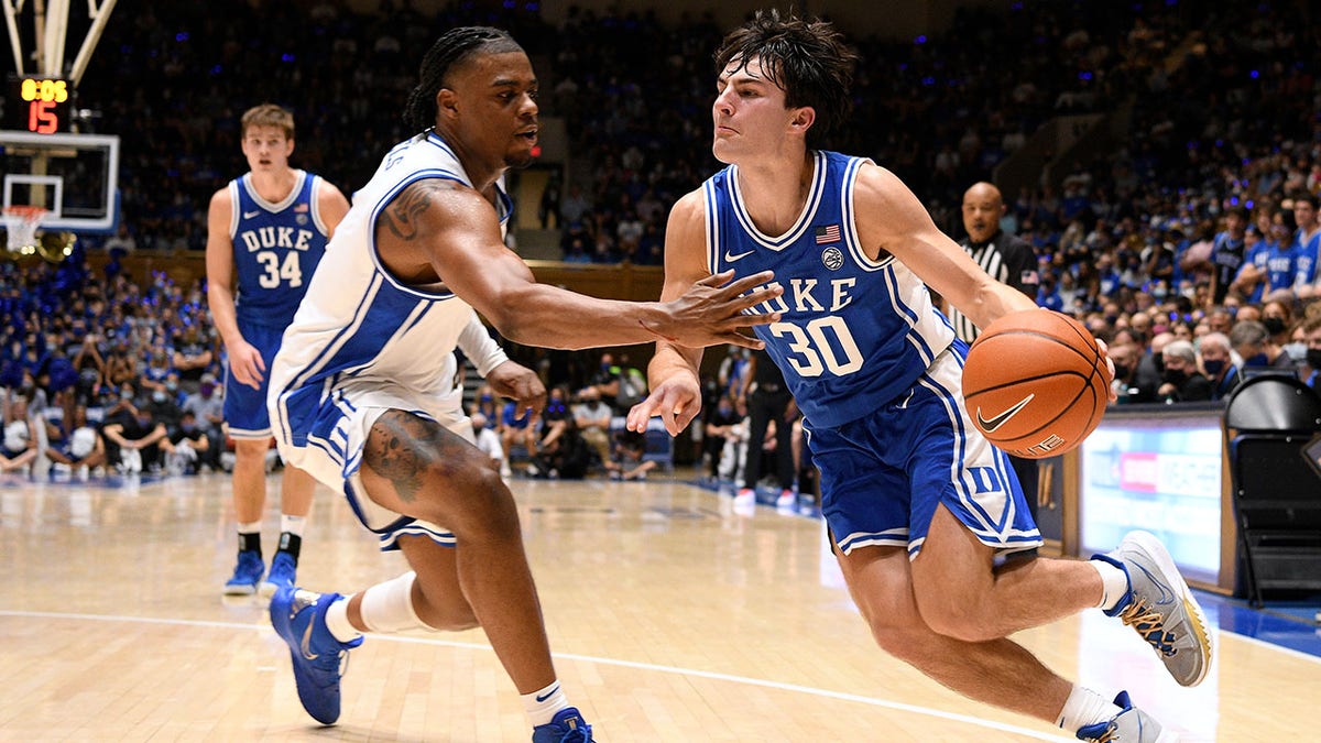 15: Michael Savarino #30 of the Duke Blue Devils drives against Trevor Keels #1 during Countdown To Craziness at Cameron Indoor Stadium on October 15, 2021 in Durham, North Carolina.