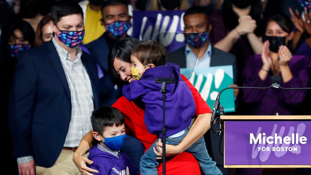 Following her victory in the mayoral race, Michelle Wu is pictured with her children Blaise and Cass and her husband Conor in Boston on Nov. 2, 2021. 