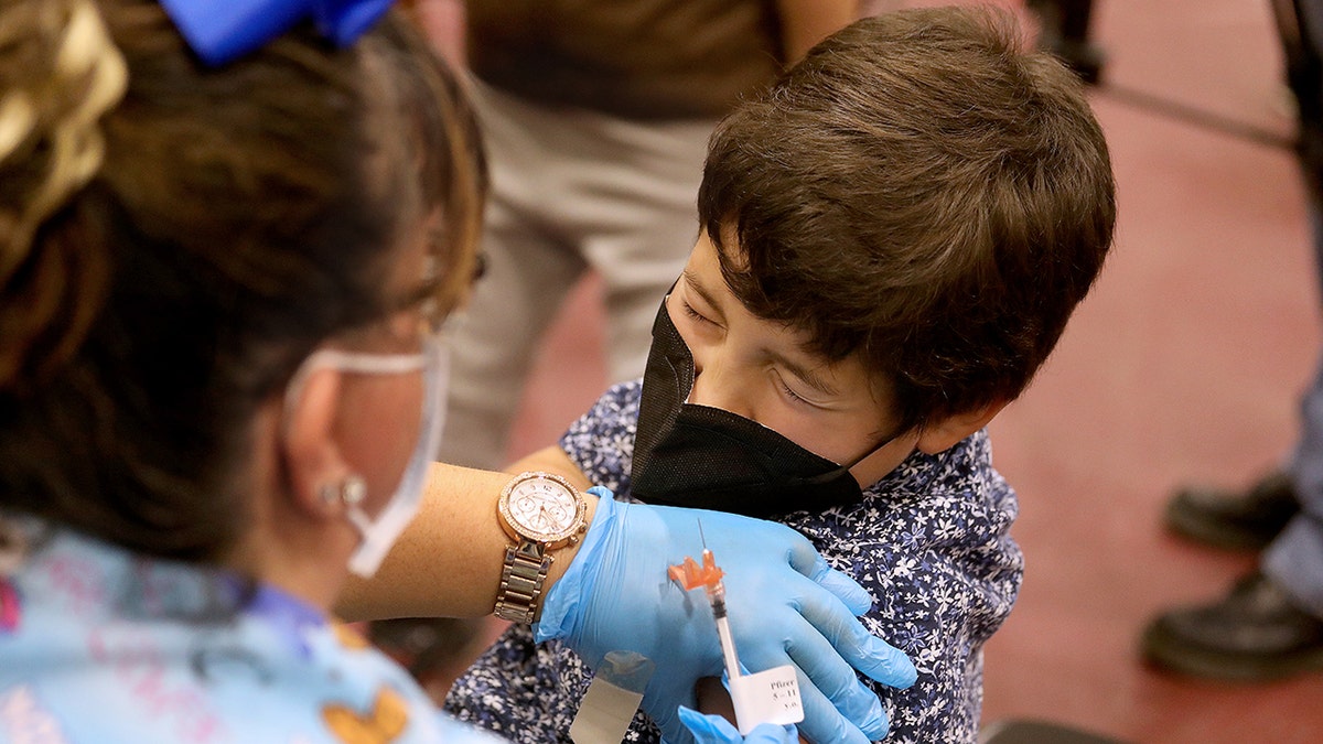 Luxiano (cq) Gonzalez, 8, of El Monte, receives a childs dose of the Pfizer vaccination from LVN Jacqueline Valdez at Eugene A. Obregon Park on Wednesday, Nov. 3, 2021 in Los Angeles, CA. (Gary Coronado / Los Angeles Times via Getty Images)