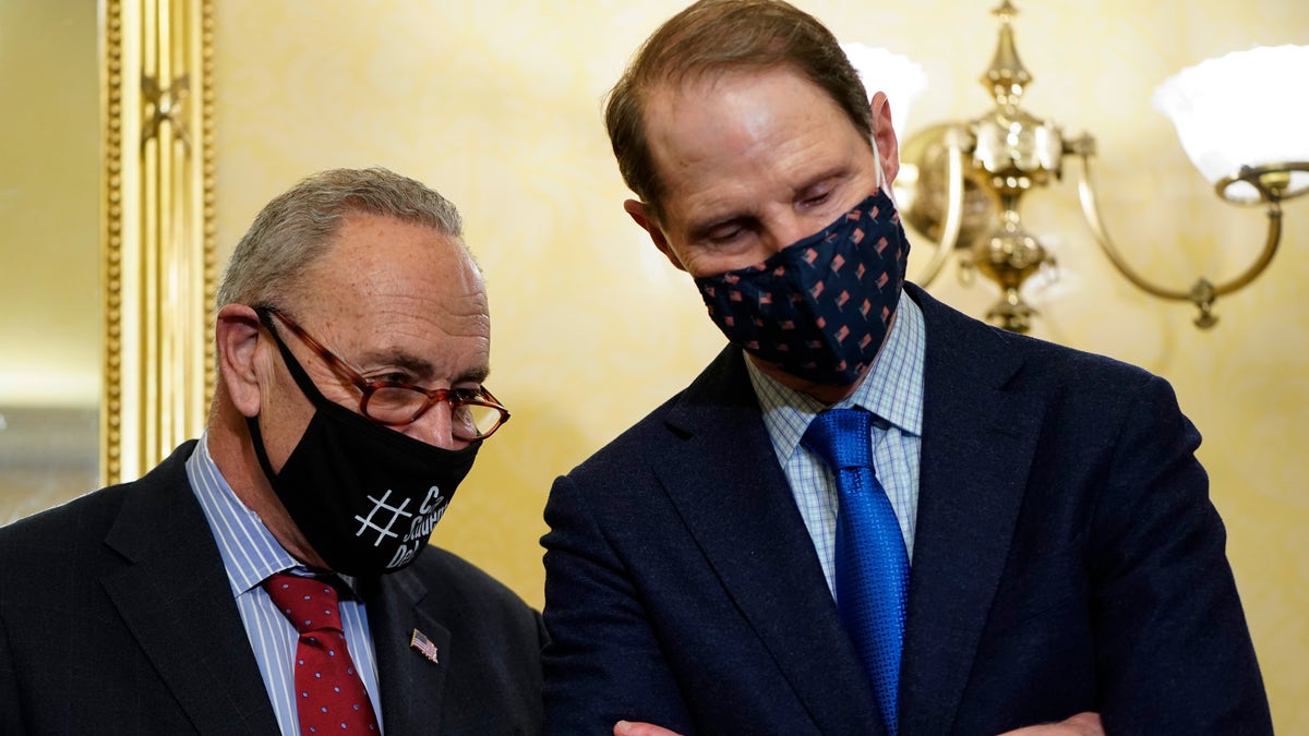 Sen. Majority Leader Chuck Schumer, D-N.Y., speaks with Sen. Ron Wyden, D-Ore., during a press conference about supply chain issues on Nov. 4, 2021, at the U.S. Capitol in Washington, D.C. ?