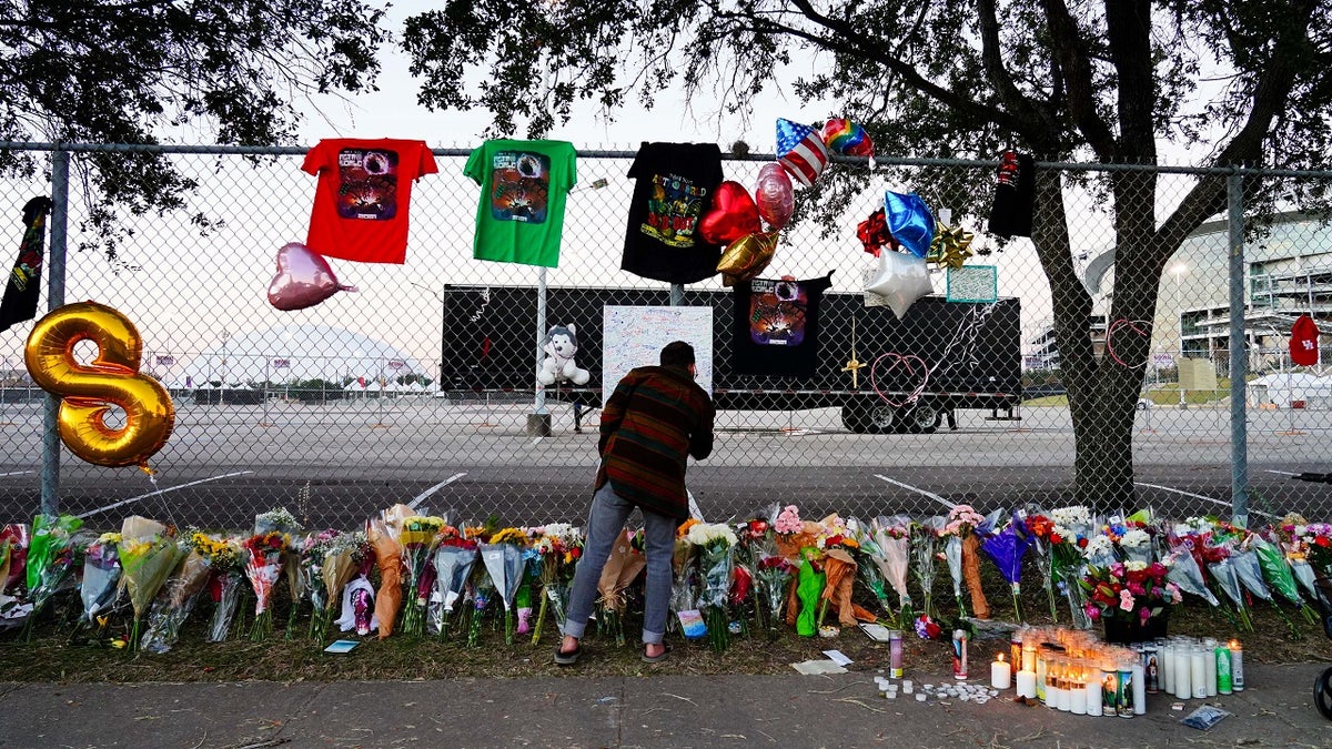 A visitor writes a note at a memorial outside of the canceled Astroworld festival at NRG Park Nov. 7, 2021 in Houston, Texas. 