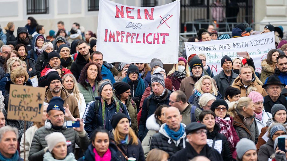 A demonstrator holds a placard stating, "No to compulsory vaccination," during an anti-vaccination protest at the Ballhausplatz in Vienna, Austria, on Nov. 14, 2021, after a Corona crisis' summit of the Austrian government. (GEORG HOCHMUTH/APA/AFP via Getty Images)
