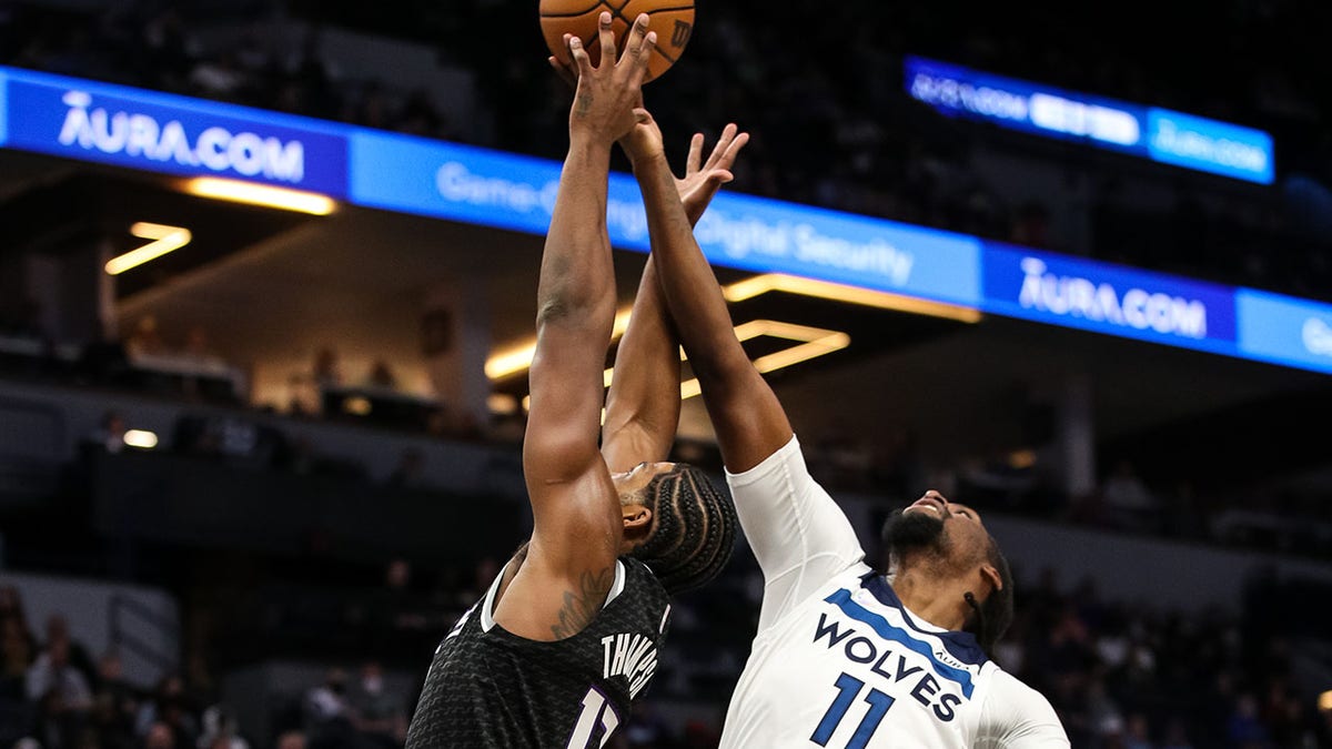 Tristan Thompson #13 of the Sacramento Kings and Naz Reid #11 of the Minnesota Timberwolves compete for a rebound in the first quarter of the game at Target Center on November 17, 2021 in Minneapolis, Minnesota.