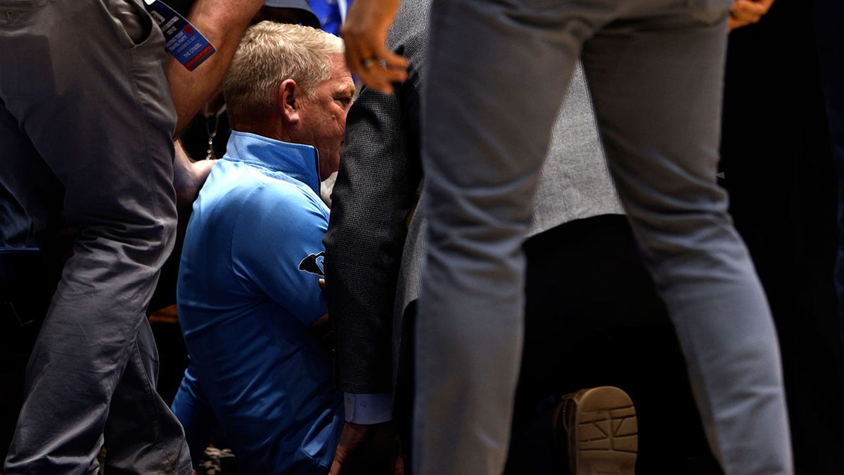 DURHAM, NC - NOVEMBER 22: Head coach Duggar Baucom of the Citadel Bulldogs receives medical attention during their game against the Duke Blue Devils in the first half at Cameron Indoor Stadium on November 22, 2021 in Durham, North Carolina.