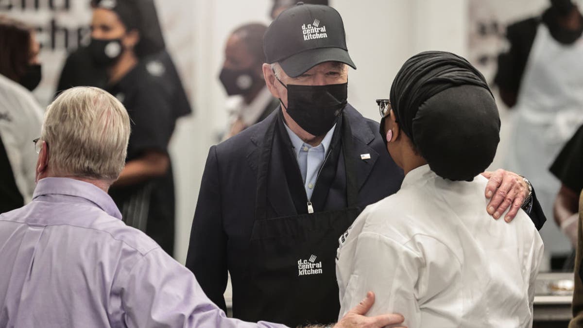 President Biden speaks with a worker before participating in a service project at DC Central Kitchen in Washington, D.C., U.S., on Tuesday, Nov. 23, 2021.
