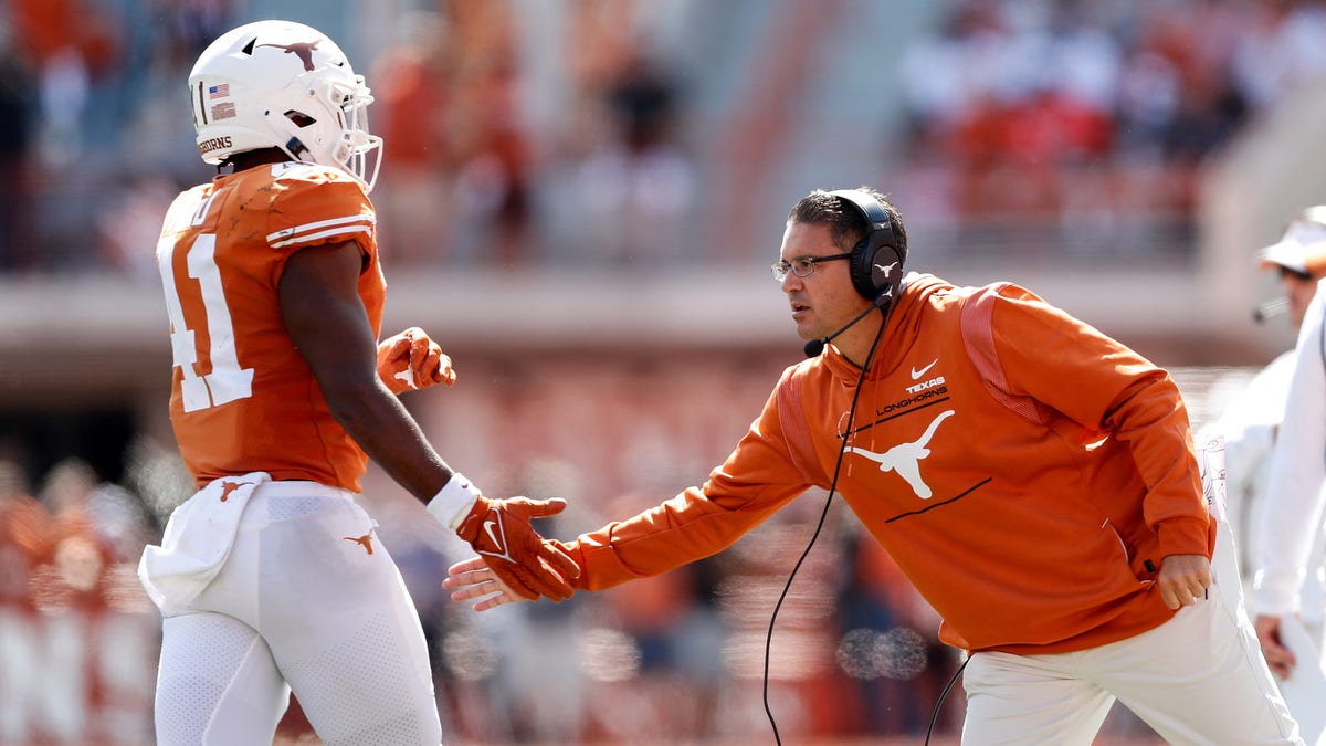 AUSTIN, TEXAS - OCTOBER 16: Special teams coordinator Jeff Banks of the Texas Longhorns congratulates Jaylan Ford #41 in the second half against the Oklahoma State Cowboys at Darrell K Royal-Texas Memorial Stadium on October 16, 2021 in Austin, Texas. (Photo by Tim Warner/Getty Images)