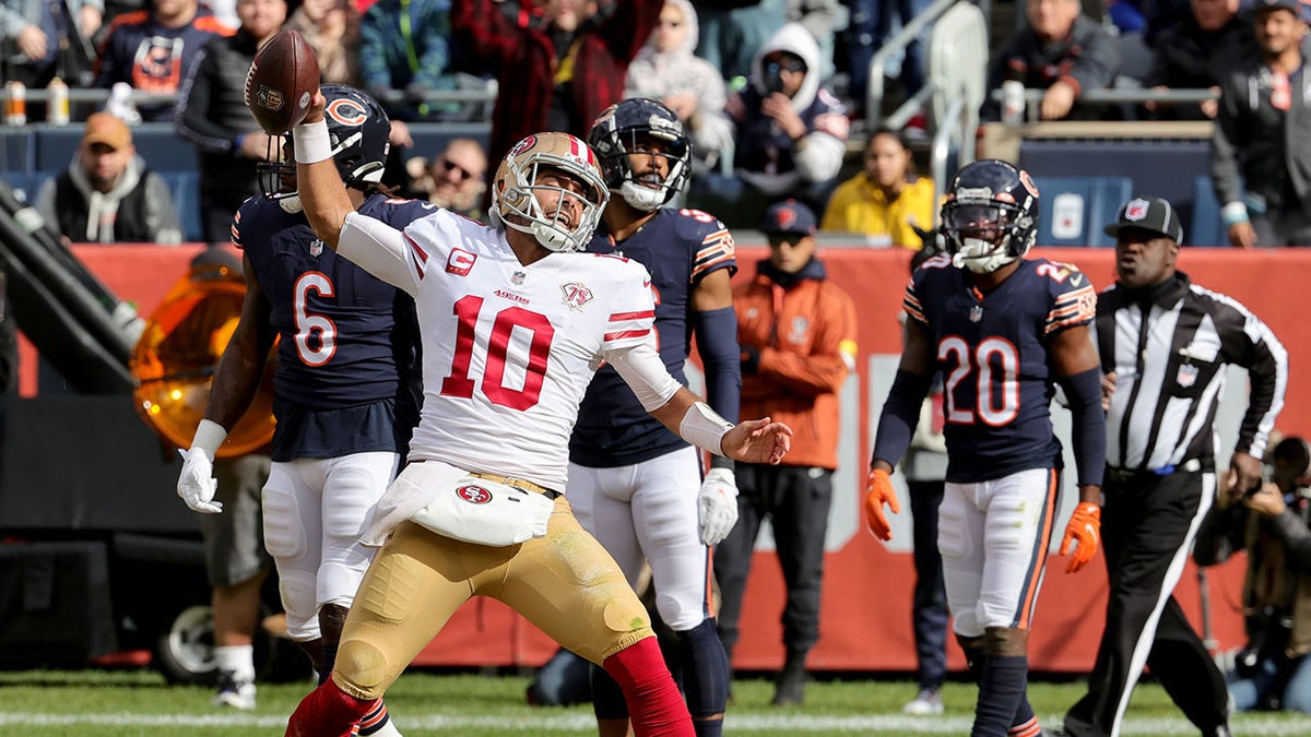 CHICAGO, ILLINOIS - OCTOBER 31: Jimmy Garoppolo #10 of the San Francisco 49ers celebrates after scoring a touchdown in the fourth quarter against the Chicago Bears at Soldier Field on October 31, 2021 in Chicago, Illinois. (Photo by Jonathan Daniel/Getty Images)