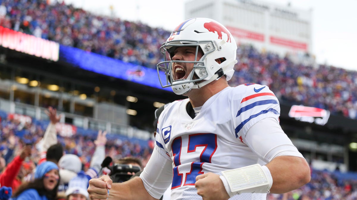 ORCHARD PARK, NEW YORK - OCTOBER 31: Josh Allen #17 of the Buffalo Bills celebrates after a touchdown run during the fourth quarter against the Miami Dolphins at Highmark Stadium on October 31, 2021 in Orchard Park, New York. (Photo by Joshua Bessex/Getty Images)