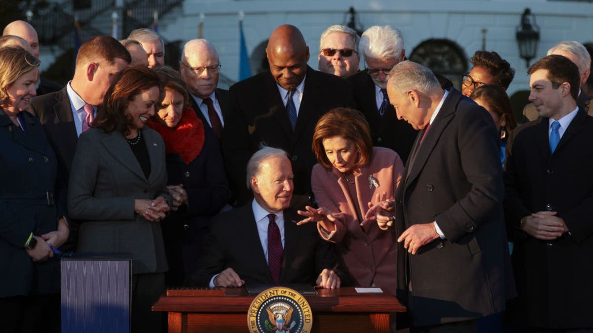 Joe Biden signs infrastructure bill, talks with Nancy Pelosi