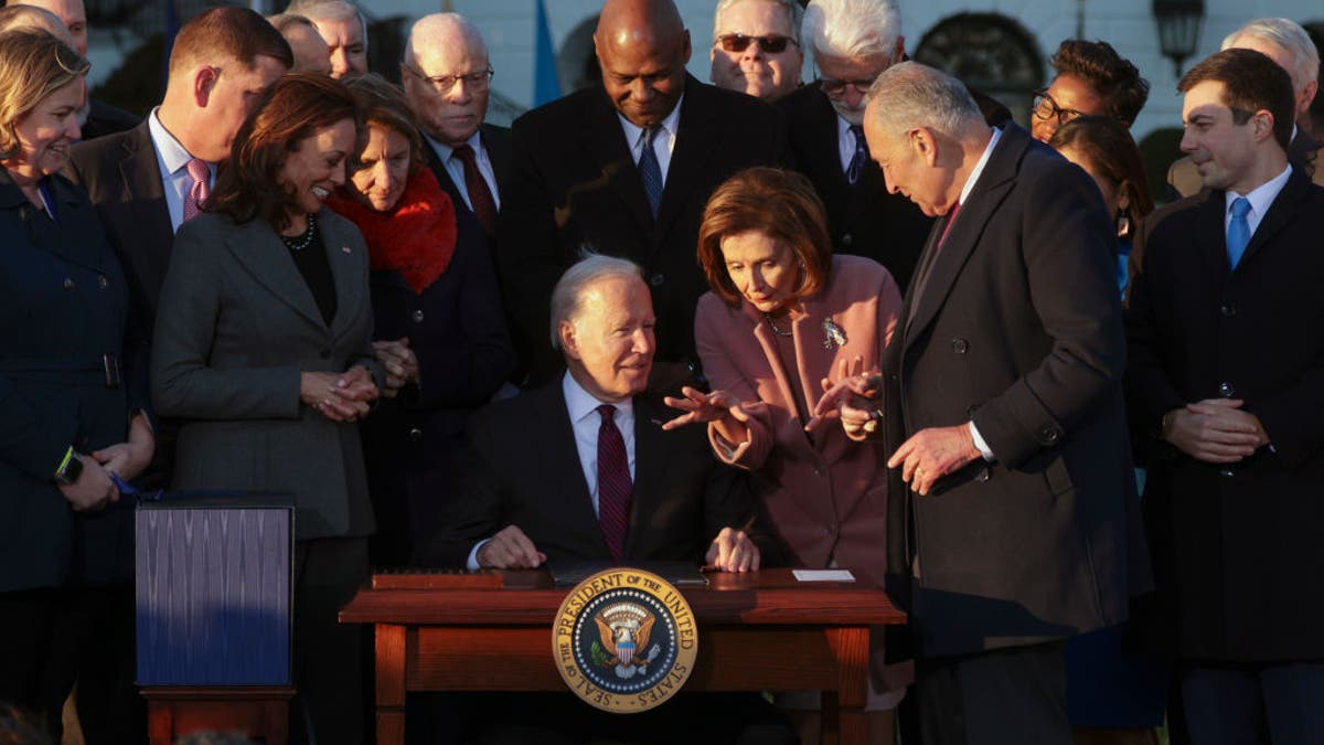 Joe Biden signs infrastructure bill, talks with Nancy Pelosi