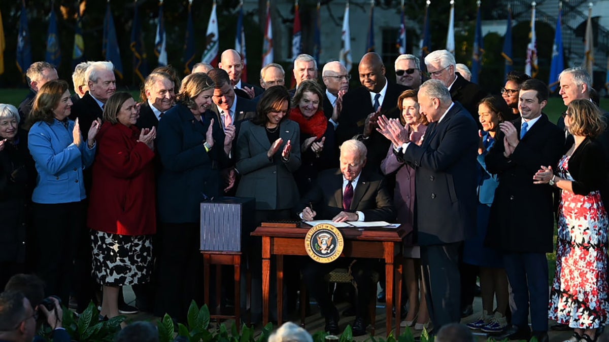 WASHINGTON, DC - NOVEMBER 15: President Joe Biden signs H.R. 3684, the Infrastructure Investment and Jobs Act, during a ceremony on the South Lawn at the White House on November 15, 2021 in Washington, DC. (Photo by Chen Mengtong/China News Service via Getty Images)