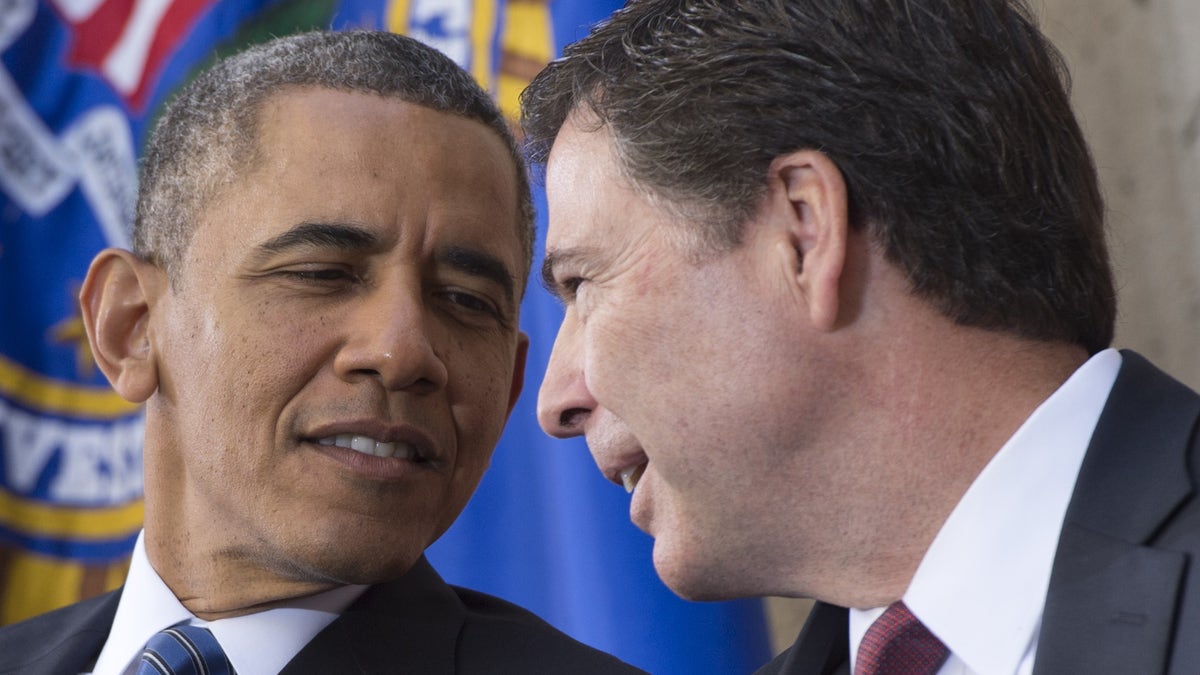 President Obama speaks with FBI Director James Comey during an installation ceremony at Federal Bureau of Investigation headquarters in Washington, D.C., Oct. 28, 2013. (SAUL LOEB/AFP via Getty Images)