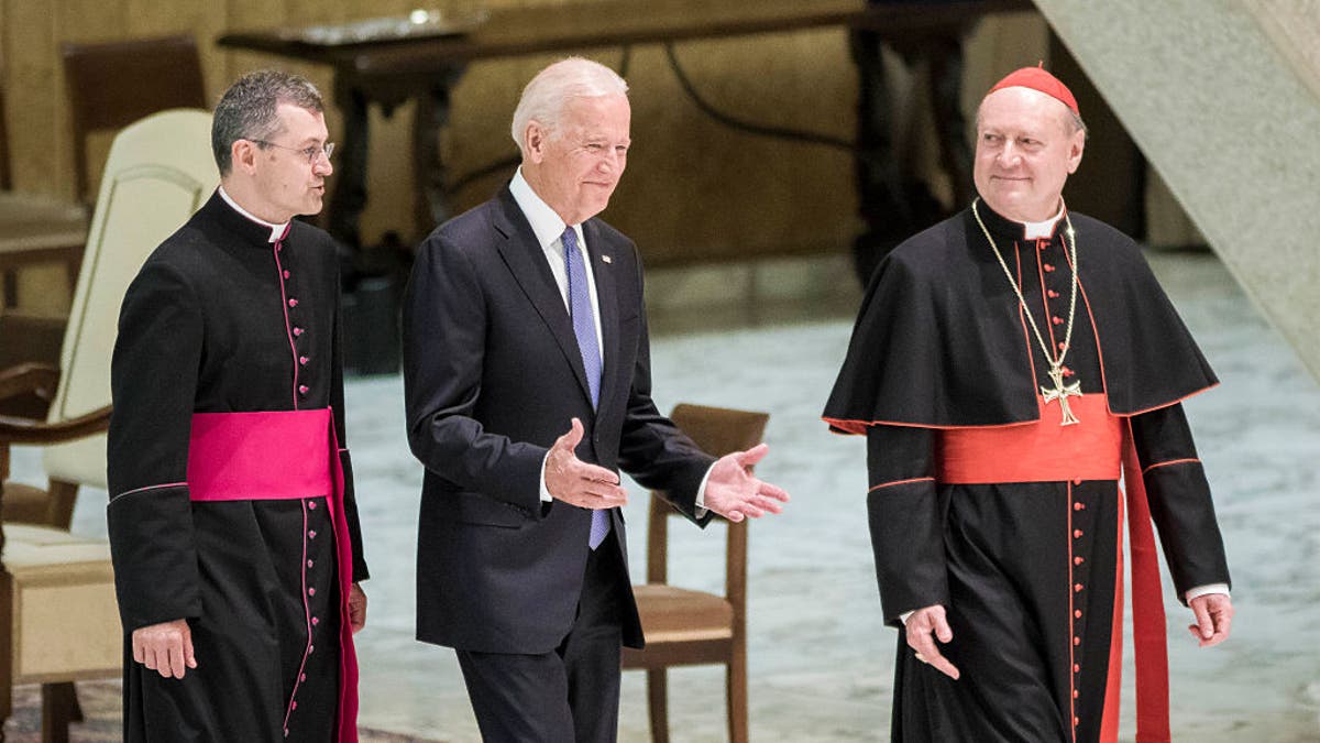 US Vice President Joe Biden (C) is flanked by Cardinal Gianfranco Ravasi (R) as he arrives to attend a special audience celebrates by Pope Francis with participants at a congress on the progress of regenerative medicine and its cultural impact in the Paul VI hall in Vatican City, Vatican on April 29, 2016.(Photo by Giuseppe Ciccia/NurPhoto via Getty Images)