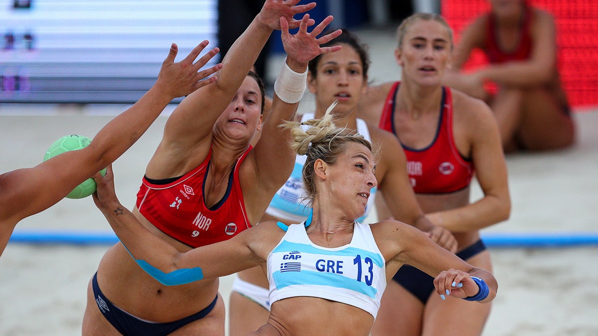 Dimitri Ntafina (right) of Greece plays a shot during the 2018 Women's Beach Handball World Cup final against Julie Aspelund Berg (left) of Norway on July 29, 2018, in Kazan, Russia. 