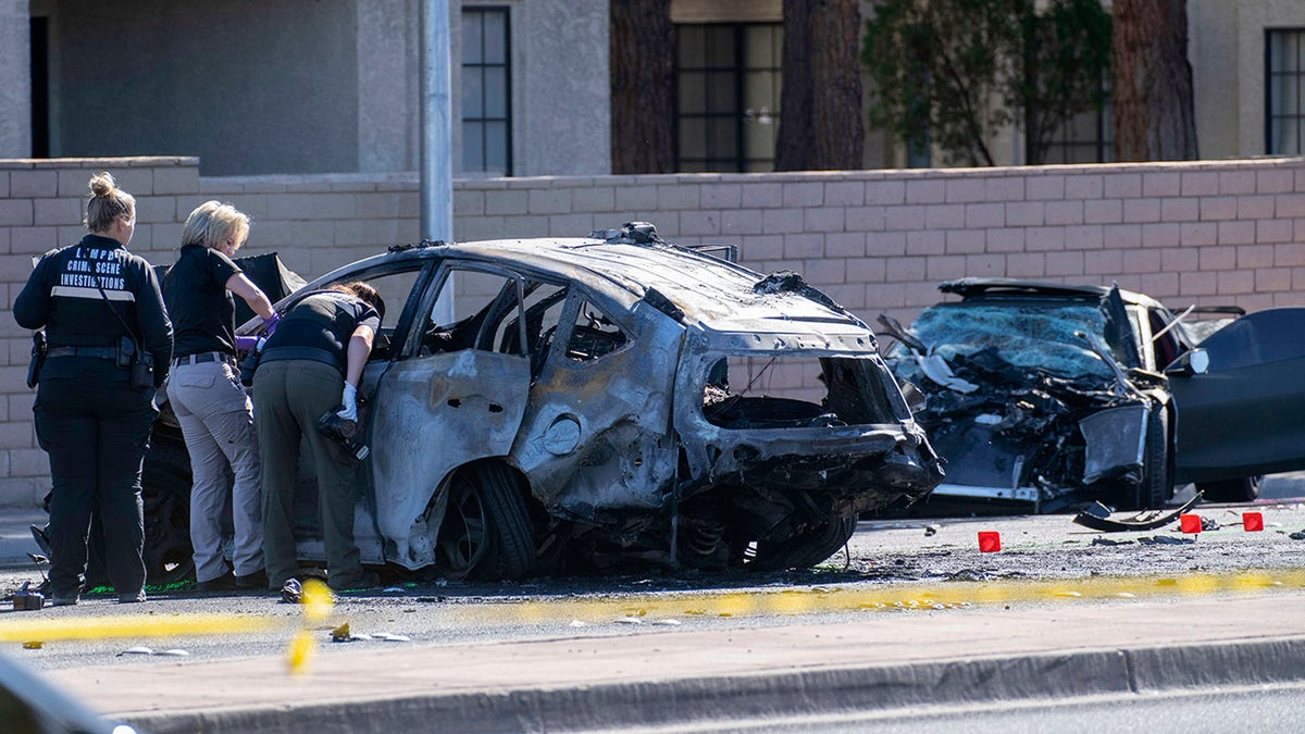 Las Vegas Metro Police investigators work at the scene of a fatal crash Tuesday, Nov. 2, 2021, in Las Vegas. Police say Raiders wide receiver Henry Ruggs III was involved in the fiery vehicle crash early Tuesday that left a woman dead and Ruggs and his female passenger injured.