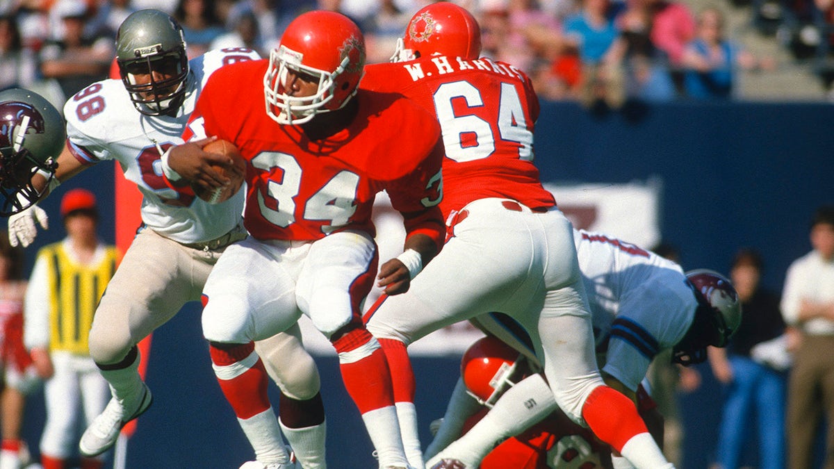 Running back Herschel Walker (34) of the New Jersey Generals carries the ball against the Birmingham Stallions in 1983 during a USFL football game at The Meadowlands in East Rutherford, N.J. Walker played for the Generals from 1983-1985.