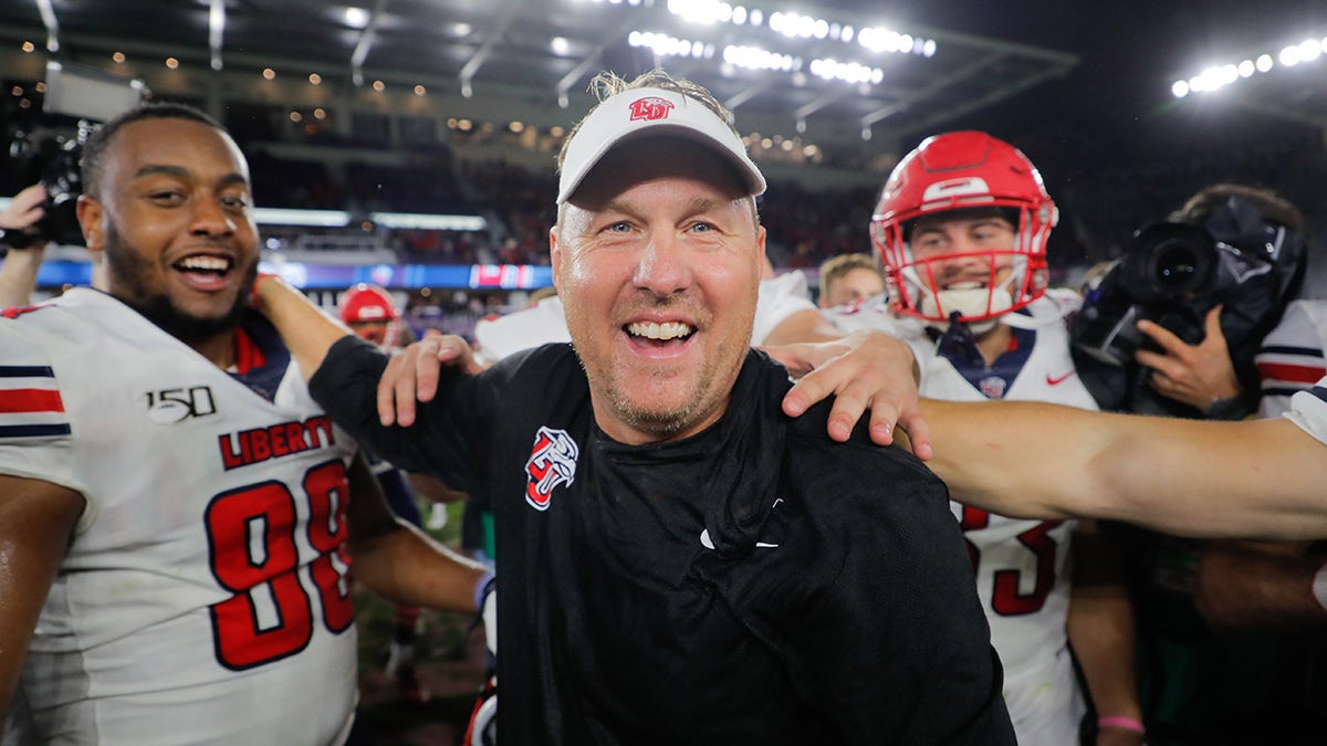 ORLANDO, FLORIDA - DECEMBER 21: Head coach Hugh Freeze of the Liberty Flames celebrates with his team after defeating the Georgia Southern Eagles in the 2019 Cure Bowl at Exploria Stadium on December 21, 2019 in Orlando, Florida.