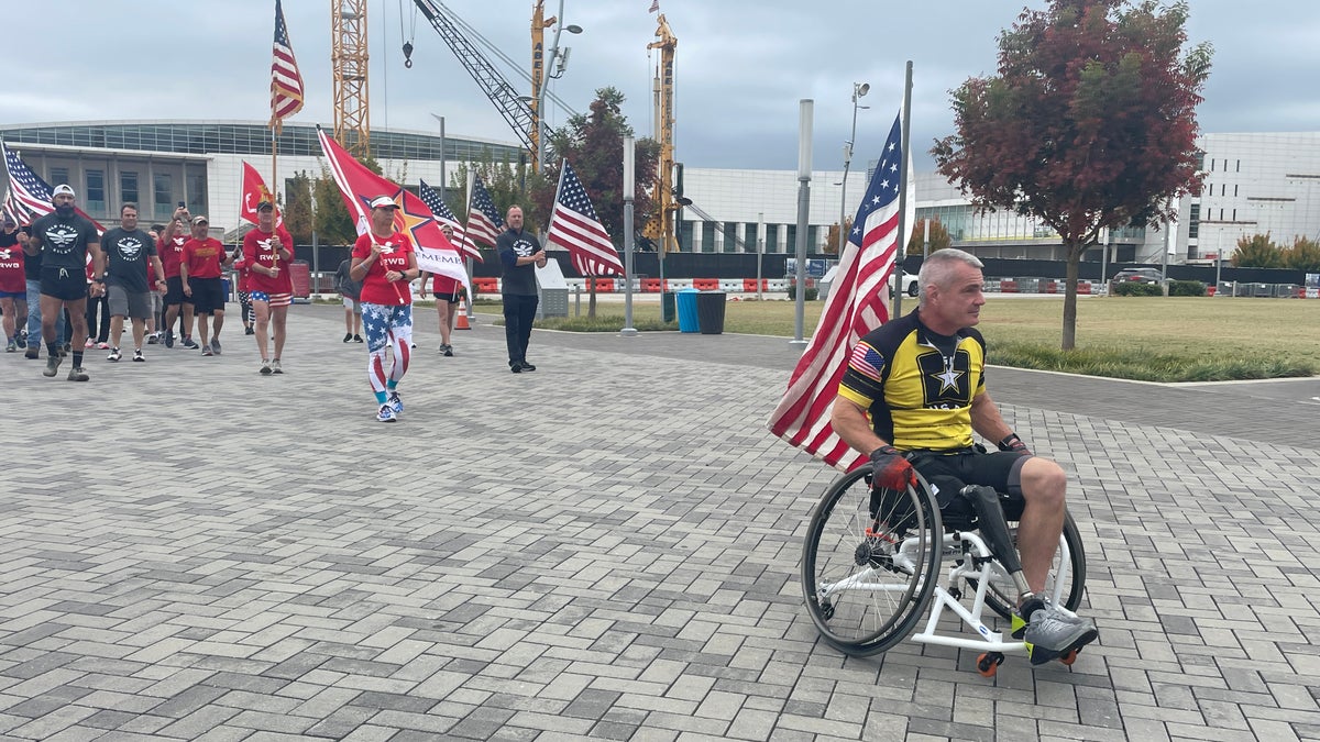 Army vet and leg amputee Rob Pierce carries the American flag as he leads a group of veterans and supporters to the finish line of Team Red, White and Blue's Old Glory Relay. (Fox News/Charles Watson)