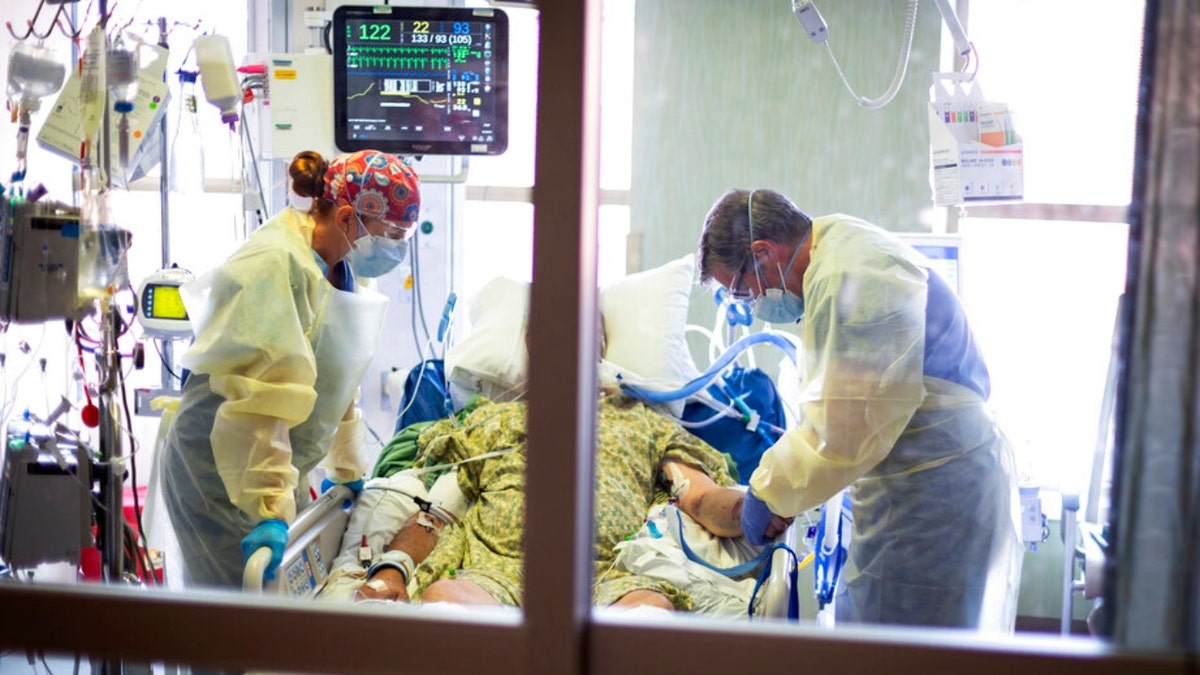 A doctor looks over a COVID-19 patient in the Medical Intensive Care Unit (MICU) at St. Luke's Boise Medical Center in Boise, Idaho, Aug. 31, 2021.