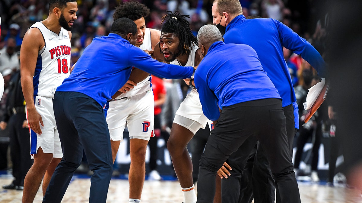 Isaiah Stewart of the Detroit Pistons is restrained after receiving a blow to the face by LeBron James of the Los Angeles Lakers during the third quarter of the game at Little Caesars Arena on Nov. 21, 2021 in Detroit, Michigan.