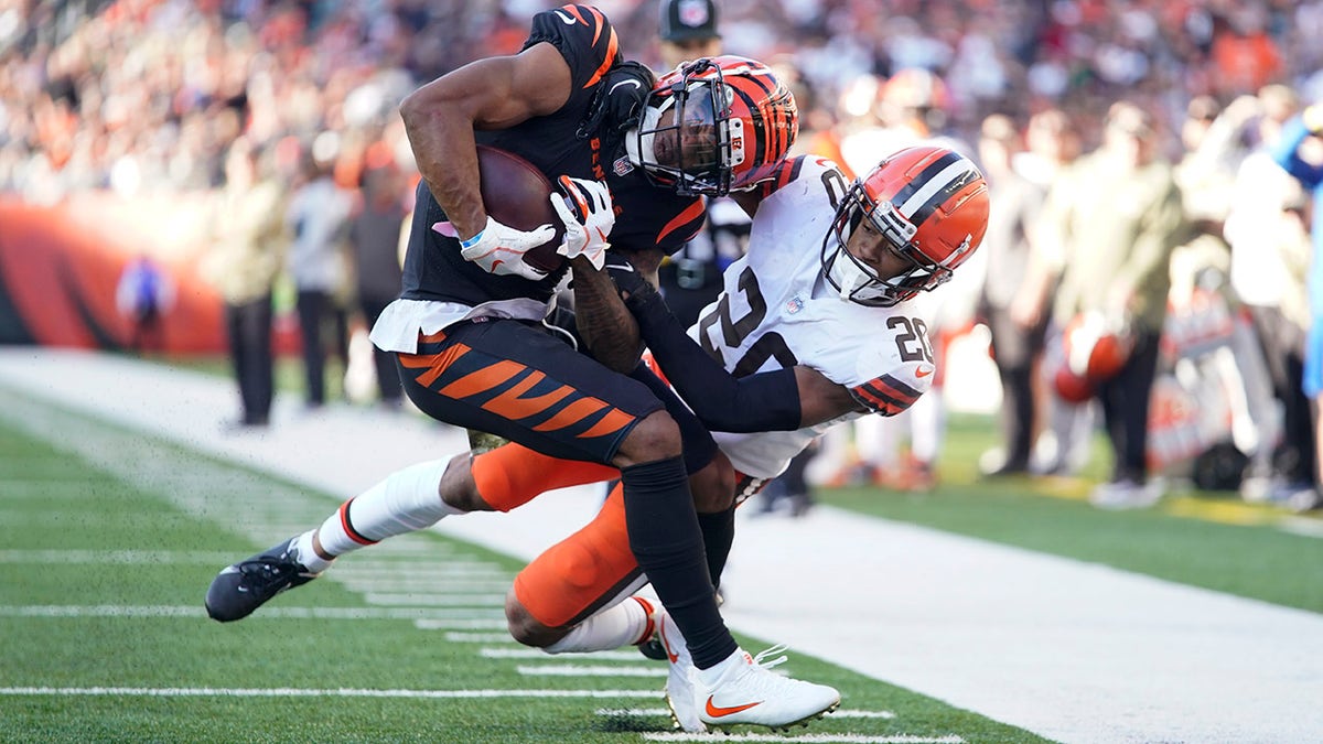 Cincinnati Bengals' Ja'Marr Chase is tackled by Cleveland Browns' Greg Newsome II on Sunday, Nov. 7, 2021, in Cincinnati.
